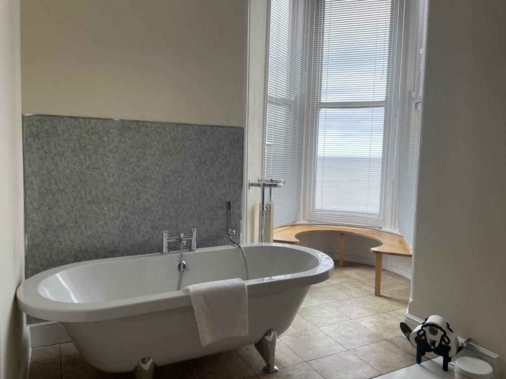 Room 7 at the Red Lion, Cromer. Sea-view suite with a balcony, luxury bath and walk-in shower